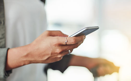 woman's hands holding a mobile