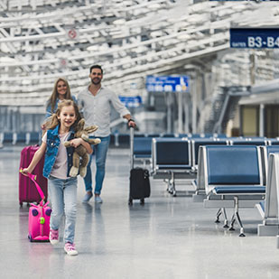 family with a kid walking at the airport